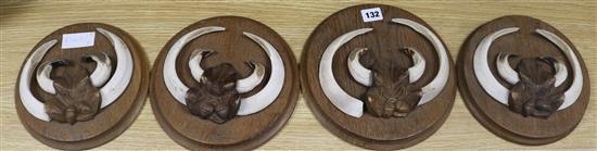 A set of four boar tusk panels diameter 24cm